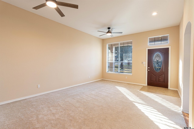 carpeted entrance foyer featuring ceiling fan