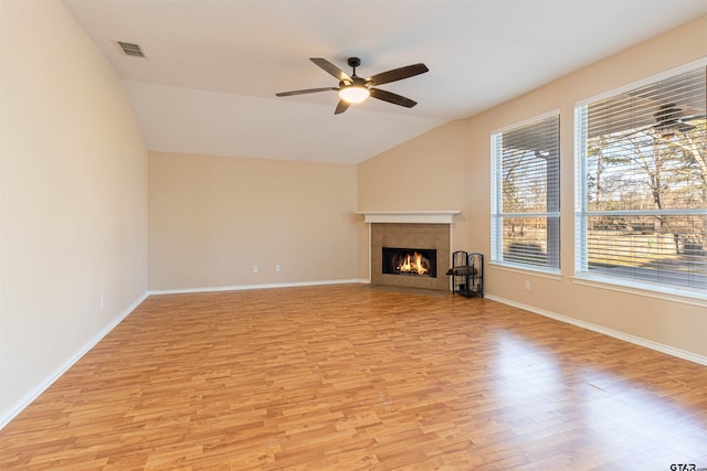 unfurnished living room featuring ceiling fan, vaulted ceiling, and light wood-type flooring