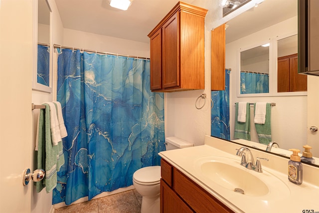 bathroom featuring curtained shower, tile patterned floors, toilet, and vanity