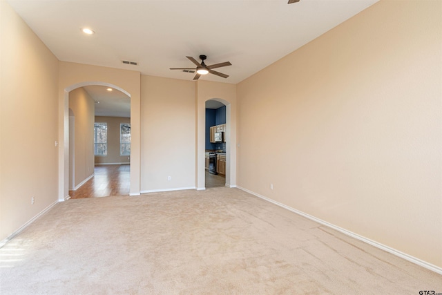 carpeted empty room featuring ceiling fan