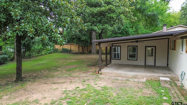 view of yard featuring ceiling fan and a patio