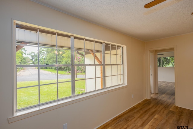 spare room with hardwood / wood-style floors and a textured ceiling