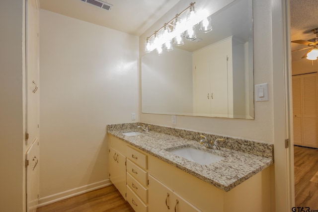 bathroom with vanity, hardwood / wood-style flooring, and ceiling fan