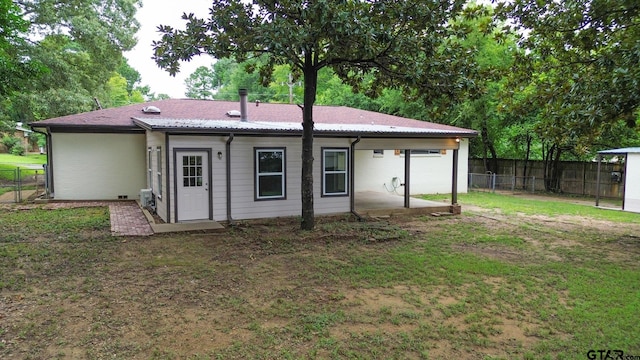 back of property featuring a yard