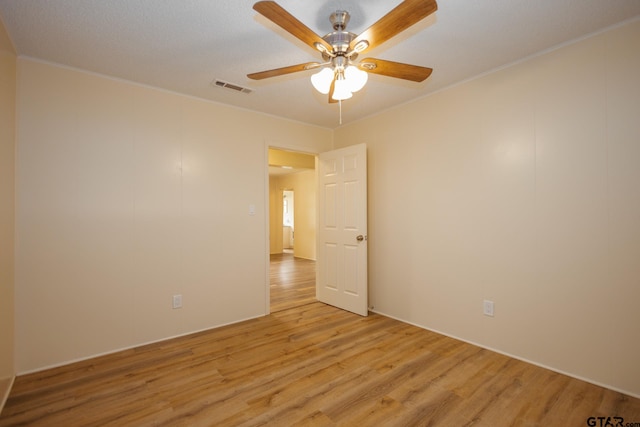 spare room with ceiling fan, light hardwood / wood-style floors, and crown molding