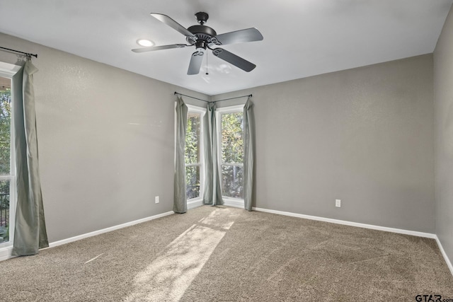 carpeted empty room featuring ceiling fan