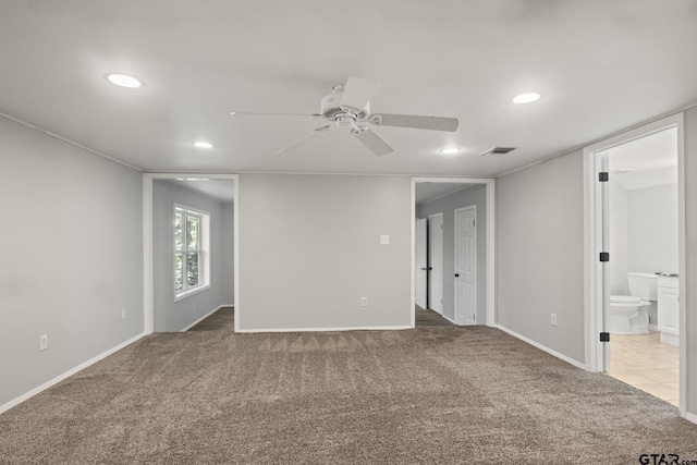 carpeted empty room featuring ceiling fan