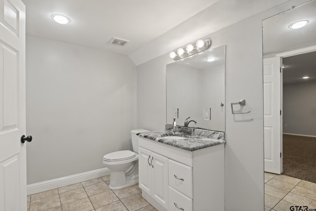 bathroom with tile patterned flooring, vanity, and toilet