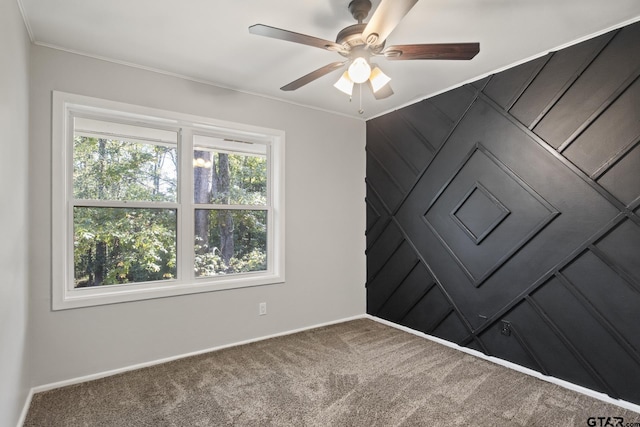 unfurnished room featuring carpet flooring, ceiling fan, and ornamental molding