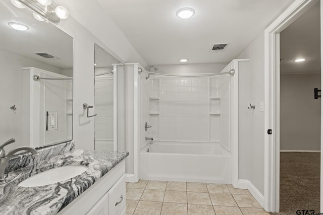 bathroom featuring tile patterned flooring, vanity, and tiled shower / bath combo