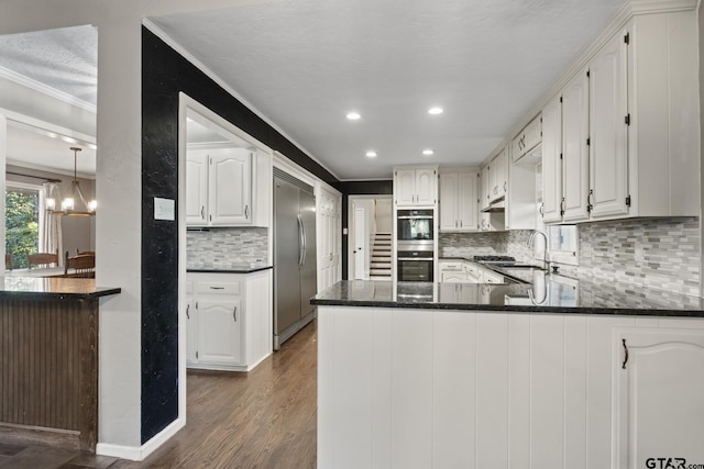 kitchen with kitchen peninsula, dark hardwood / wood-style flooring, and white cabinets