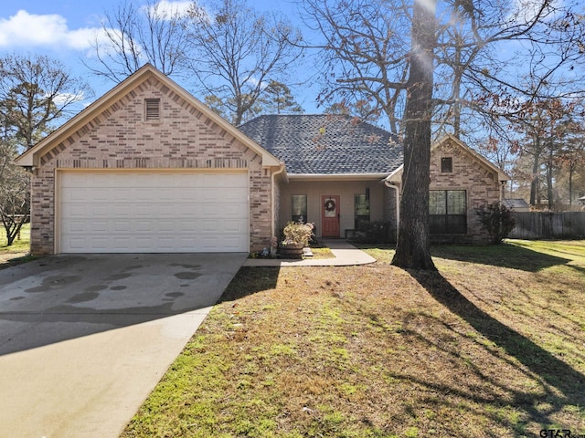 view of front of home featuring brick siding, an attached garage, concrete driveway, and a front lawn