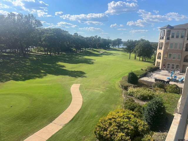 surrounding community with a patio and a lawn