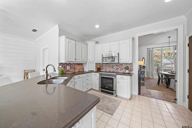 kitchen featuring decorative backsplash, white cabinets, sink, and stainless steel appliances