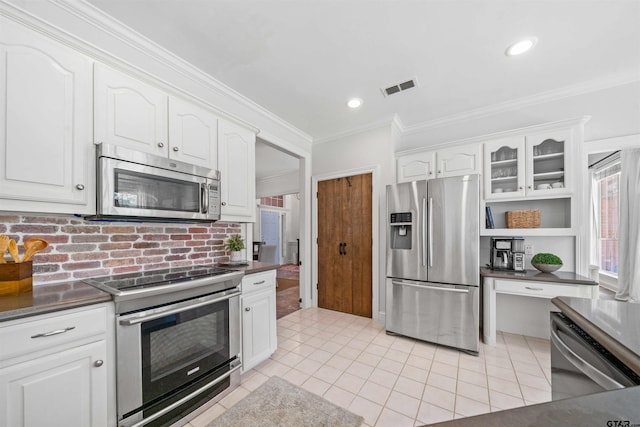 kitchen featuring stainless steel appliances, white cabinetry, and crown molding