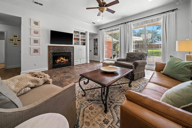 11213 Chasewood Dr, Tyler, TX 75703 - living room featuring built in features, baseboards, a ceiling fan, crown molding, and a fireplace