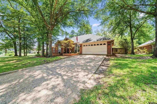 11213 Chasewood Dr, Tyler, TX 75703 - view of front facade featuring driveway, an attached garage, and brick siding