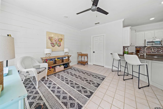 11213 Chasewood Dr, Tyler, TX 75703 - living area with crown molding, ceiling fan, light tile patterned floors, and baseboards