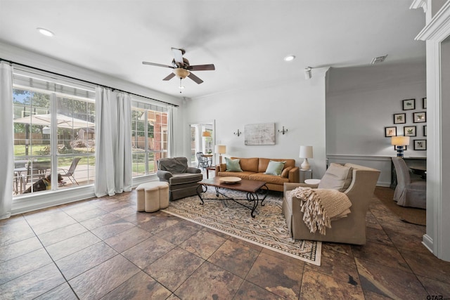 living room with ceiling fan and ornamental molding