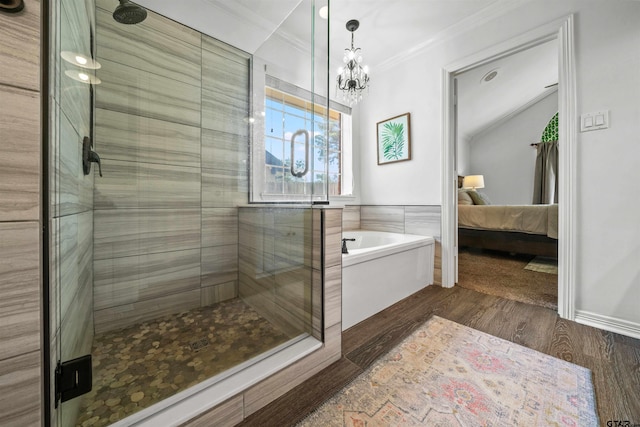 bathroom featuring wood-type flooring, a chandelier, crown molding, and independent shower and bath