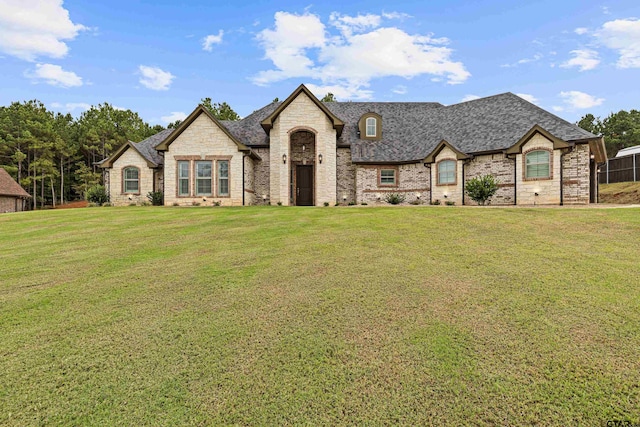 french country home featuring a front lawn