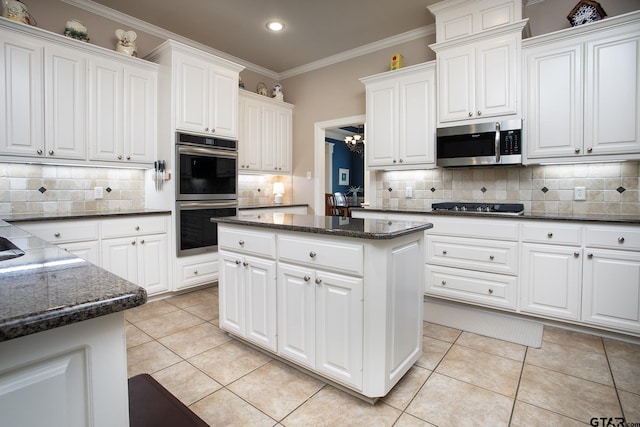 11208 Marsh Wren Cir, Flint, TX 75762 - kitchen featuring appliances with stainless steel finishes, backsplash, recessed lighting, white cabinets, and ornamental molding