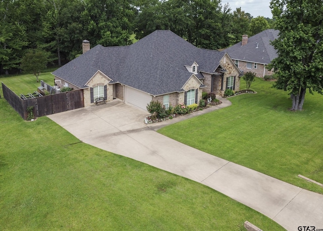 11208 Marsh Wren Cir, Flint, TX 75762 - view of front of property with a chimney, stone siding, driveway, brick siding, and an attached garage