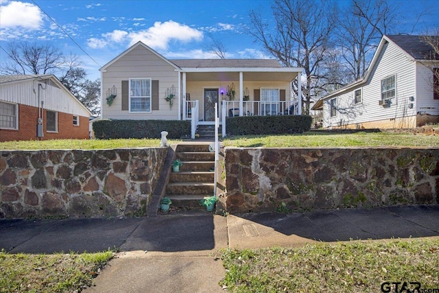 view of front of home with covered porch and a fenced front yard