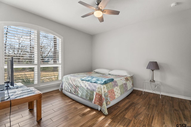 bedroom with dark wood-type flooring and ceiling fan