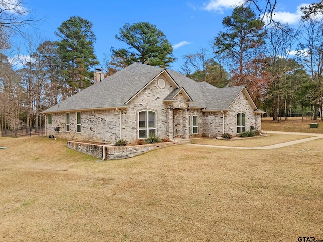 french provincial home with a front yard