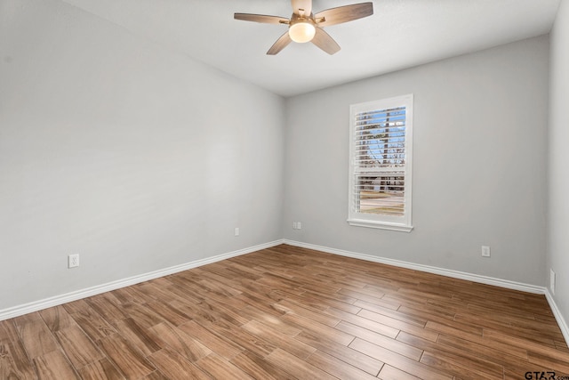 empty room with ceiling fan and light hardwood / wood-style flooring