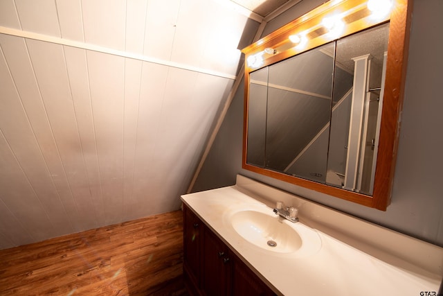 bathroom with vanity and hardwood / wood-style flooring