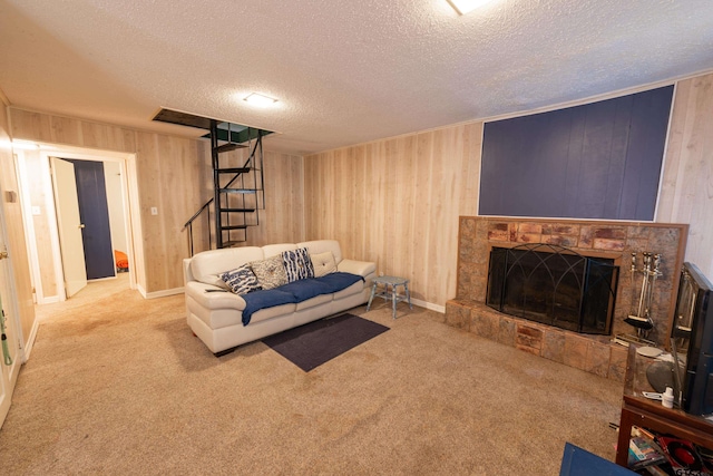 living room with a fireplace, a textured ceiling, and carpet