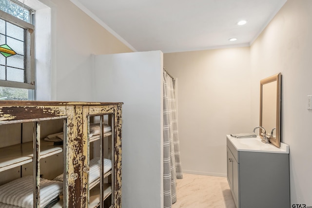 bathroom featuring vanity and ornamental molding