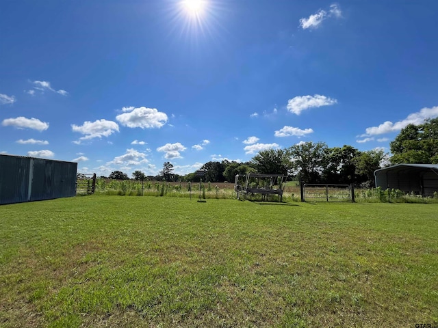 view of yard with a rural view