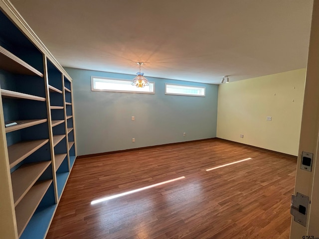 unfurnished room with hardwood / wood-style floors and plenty of natural light