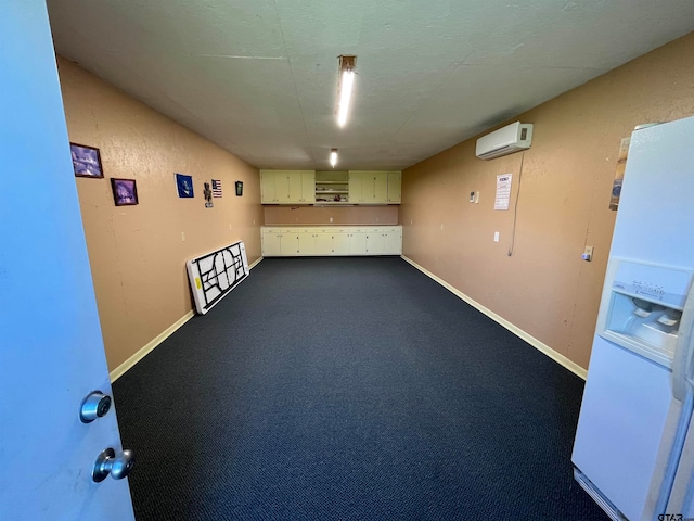 basement with carpet flooring, an AC wall unit, and white fridge with ice dispenser