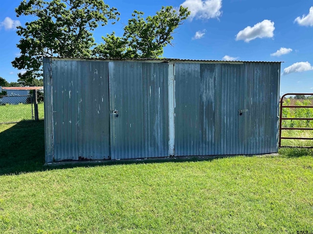 view of outdoor structure with a lawn