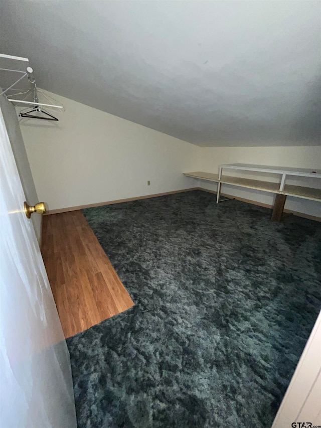 walk in closet featuring dark carpet