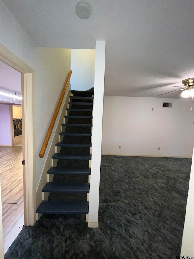 stairs with washer / clothes dryer, carpet, and ceiling fan