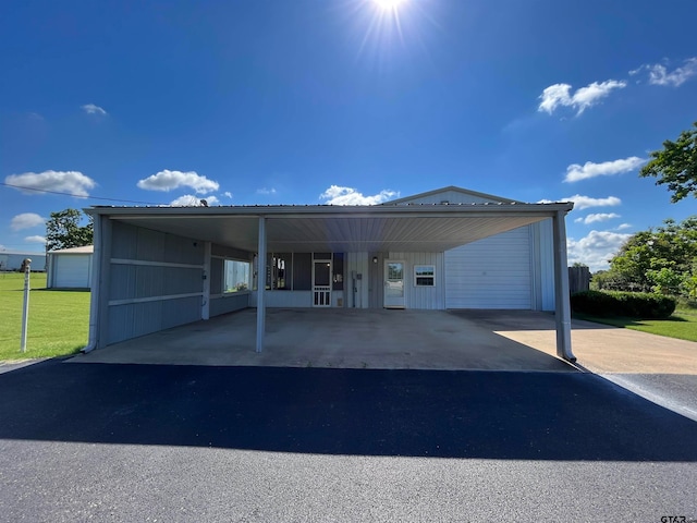 view of front of house featuring a garage and a carport