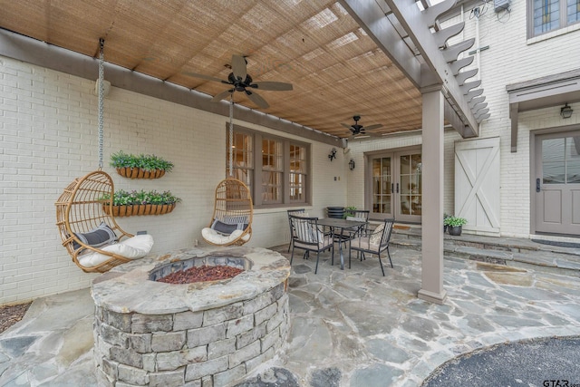 view of patio / terrace featuring french doors, ceiling fan, and an outdoor fire pit