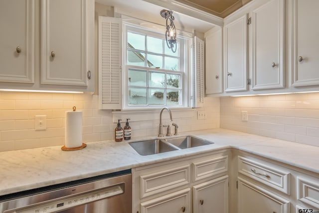 kitchen featuring sink, white cabinetry, hanging light fixtures, dishwasher, and backsplash