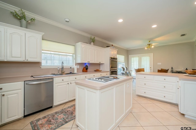 3 Casey Ct, Longview, TX 75604 - kitchen featuring appliances with stainless steel finishes, crown molding, light tile patterned flooring, white cabinets, and ceiling fan