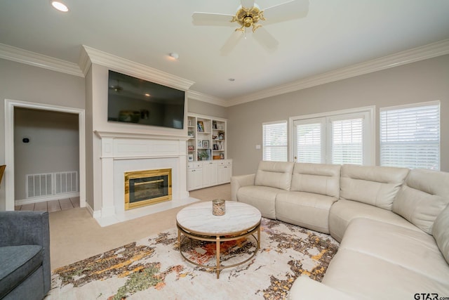 3 Casey Ct, Longview, TX 75604 - carpeted living room with ornamental molding, a ceiling fan, and a fireplace with flush hearth