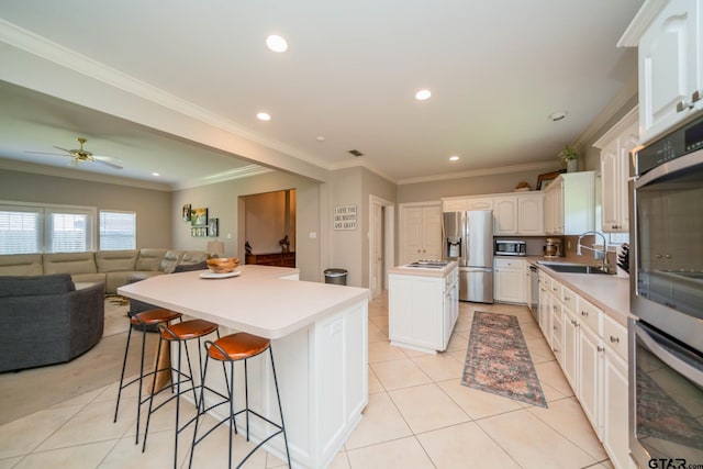 3 Casey Ct, Longview, TX 75604 - kitchen with stainless steel appliances, a center island, open floor plan, a breakfast bar, and a ceiling fan