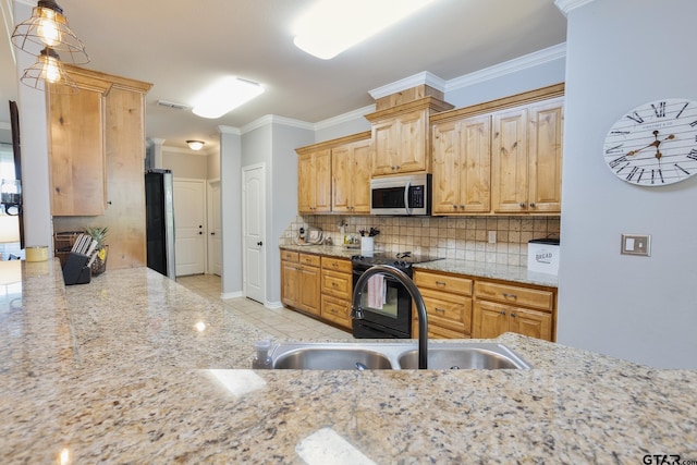 702 Jaxon Dr, Whitehouse, TX 75791 - kitchen featuring stainless steel microwave, tasteful backsplash, ornamental molding, light stone counters, and pendant lighting