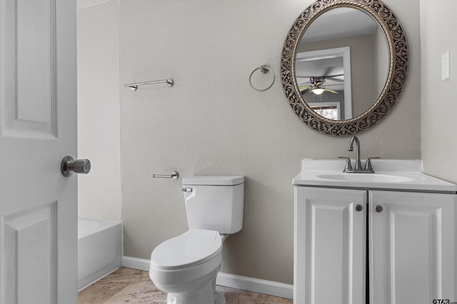 bathroom featuring baseboards, toilet, ceiling fan, a washtub, and vanity