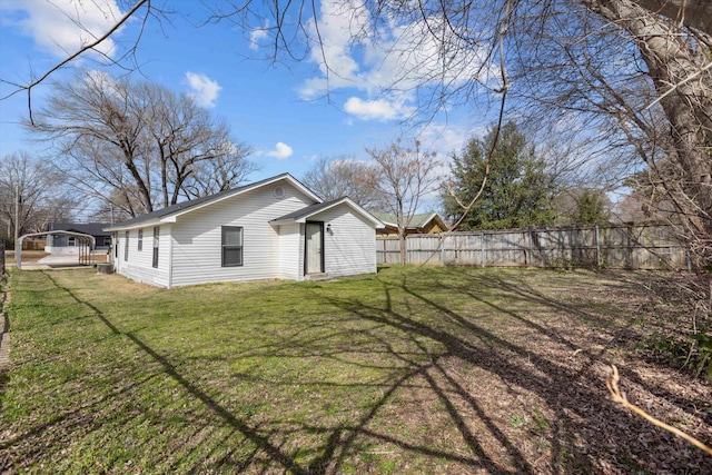 exterior space featuring fence and a lawn