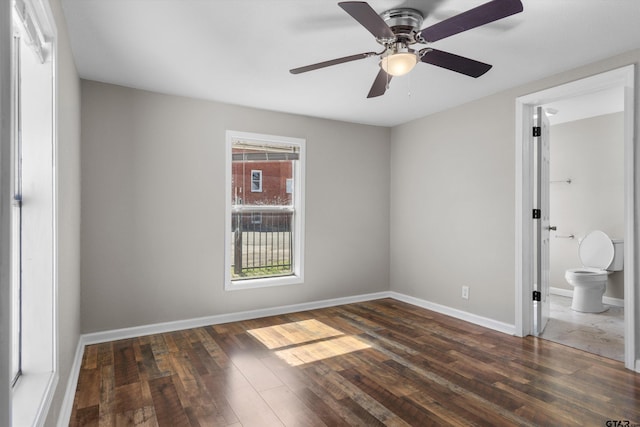 unfurnished bedroom featuring a ceiling fan, dark wood finished floors, and baseboards